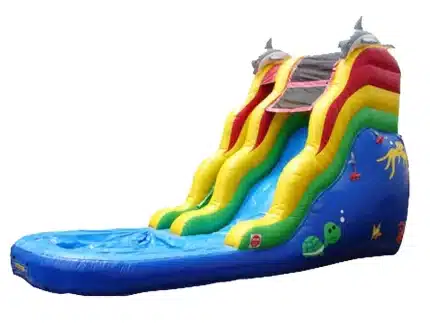 Ocean-themed inflatable water slide with bright colors, dolphin accents, and attached pool. Perfect for summer parties. Buy this fun slide online today!
